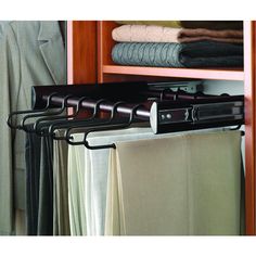 a closet with clothes hanging from it's rails and two coats on hangers