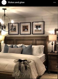 a bed with pillows and pictures on the wall above it