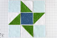 a green and blue patchwork quilt block