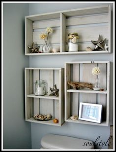 some shelves that are on the wall above a toilet