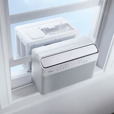 an air conditioner sitting on top of a window sill