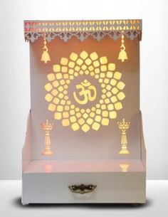 an illuminated lamp with the omesha symbol on it's display stand and candles