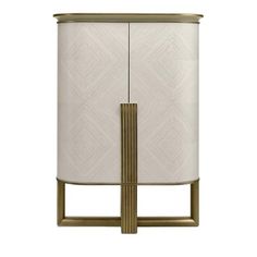 a white and gold cabinet with a lamp on top