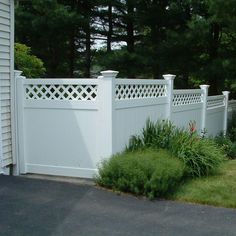 a white fence in front of a house