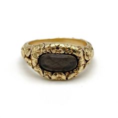 An early nineteenth century gold mourning ring featuring a heavily carved floral pattern throughout and centering an oval compartment with a plait of braided brown hair, engraved to the reverse: W. H. Crowder ob. 3 Mar. 1816 aet 21 (W. H. Crowder died 3 Mar 1816 age 21), size 6 and not sizable, 6.0 grams.  During the early nineteenth century it was common for women to adorn themselves with multiple rings of every shape and style, from amatory rings to mourning rings. As such, a rich diversity of Victorian Engraved Ring With Rose Cut Diamonds, Victorian Oval Engraved Ring With Rose Cut Diamonds, Antique Oval Engraved Ring With Rose Cut Diamonds, Ceremonial Oval Cabochon Rings, Ceremonial Oval Signet Ring With Intaglio, Ceremonial Oval Intaglio Ring, Victorian Yellow Gold Carved Rings, Victorian Carved Yellow Gold Rings, Formal Oval Carved Signet Ring