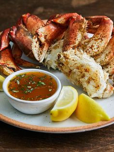 crab legs with dipping sauce and lemon wedges