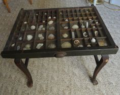 an old table with shells in it on the floor