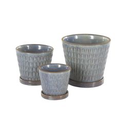 three gray cups and saucers sitting on top of each other with brown rims