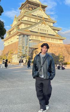 a man standing in front of a tall building