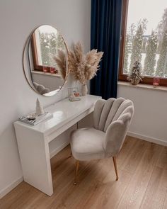 a white desk with a mirror and chair in front of it on top of a hard wood floor