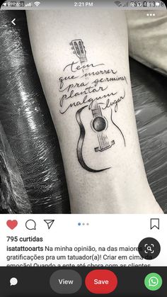 a person with a guitar tattoo on their arm