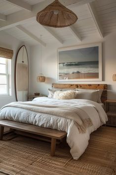 a large bed sitting in a bedroom on top of a wooden floor next to a window