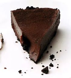 a piece of chocolate cake sitting on top of a white plate