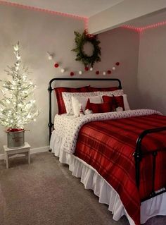 a bedroom decorated for christmas with red and white bedding