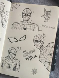 an open notebook with drawings of spider - man's faces and hands on it