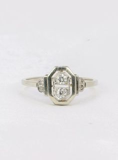 an antique ring with three diamonds on it