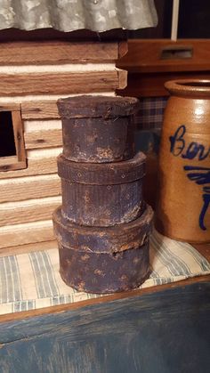 a stack of old tin cans sitting on top of a table