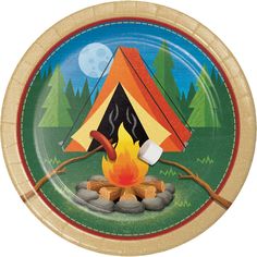 a paper plate with a campfire and tent design on the front, surrounded by trees