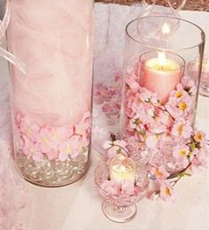 two vases filled with pink flowers next to each other