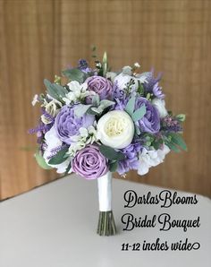 a bridal bouquet with purple and white flowers