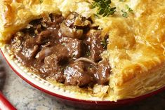 a close up of a pie with meat and mushrooms