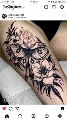 a woman's thigh with black and white tattoos on her legs, the butterfly is surrounded by flowers