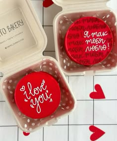 two valentine's day magnets in plastic containers