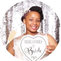 a woman holding up a sign that says here comes the bride