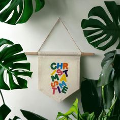 a banner hanging on a wall with the words'chir de mat supreme'in multi - colored letters