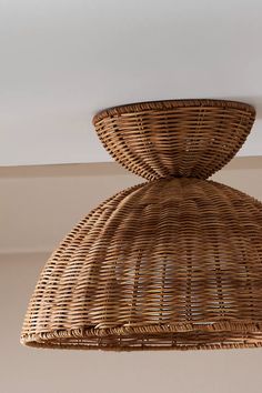 a wicker light fixture hanging from the ceiling