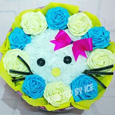 a hello kitty cake decorated with blue and white roses