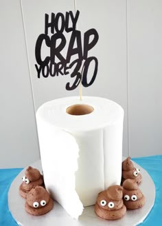 a roll of toilet paper sitting on top of a table next to some fake eyes