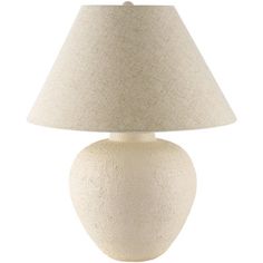 a white table lamp with a beige shade on the base and a light bulb attached to it