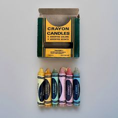 an assortment of crayon candles in a box