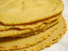 a stack of corn tortillas sitting on top of a white cloth