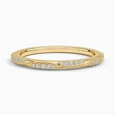 a yellow gold wedding band with diamonds