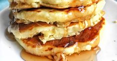 three pancakes stacked on top of each other with syrup drizzled over them