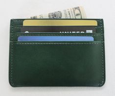 This slim card holder is inspired by watermelon and made out of vegetable-tanned Forest Green leather and is lined with Reddish Pink Italian leather. It will develop a nice patina over time because of the leather's natural character. Dimensions / Features: Length: 4.25'' Height: 3'' Width:0.3 '' 1 Middle slip pocket for cash of receipts 6 Card slips Craftsmanship: Handcrafted from start to finish by a single craftsman The leather pattern is cut by hand  Decorative and durable traditional saddle stitching Painted and polished edges for a nice, finished look  Please Note: The color of the leather may look slightly different from screen to screen. Thank you for visiting PujjeD Shop. If you have any questions about this cardholder, please feel free to message me. Green Wallets With Card Slots, Handmade Green Rectangular Wallet, Luxury Green Wallets With Card Slots, Green Leather Wallet With Card Slots, Luxury Green Leather Card Holder, Extra Accessories, Slim Wallet, Leather Pattern, Money Clip Wallet