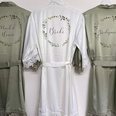 two robes with embroidered bride and groom names on them, one is green and the other is white