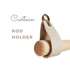 a wooden holder with a leather handle on it and the words curtain rod holder above it