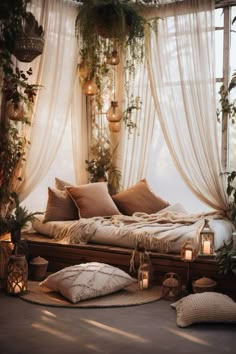 a bed with lots of pillows on top of it in front of a large window