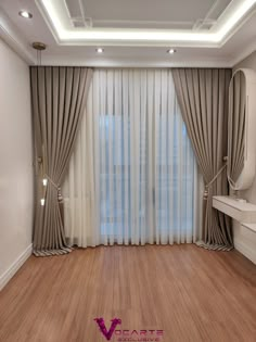 an empty room with wooden floors and drapes on the windowsill, along with a mirror