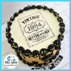 Vintage 1984 themed birthday cake with elegant black and gold design details 46th Birthday Cakes For Men, Great Gatsby 40th Birthday Cake, 100th Birthday Cakes For Men, Vintage Aged To Perfection Cake, 70 Th Birthday Cakes For Men, Birthday Cake For 60 Year Old Man, 90 Th Birthday Cake Ideas, Vintage Birthday Cakes For Men, 50 Cake Birthday For Women