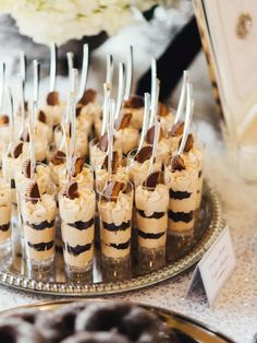 desserts are arranged on a silver platter and ready to be served at an event