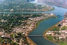 an aerial view of a river running through a city