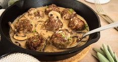 a skillet filled with meatballs covered in gravy