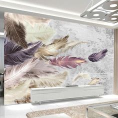 a living room filled with furniture and a large wall mural covered in colorful feather feathers