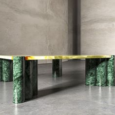 a marble table with three columns in front of it and an abstract design on the top