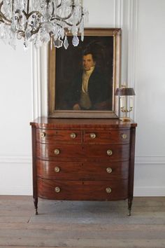 an antique dresser with a painting on it