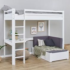 a white loft bed sitting on top of a wooden floor